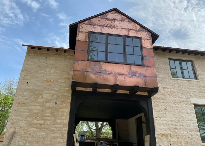 Copper metal panel facade on a stone building for Skylight Installation in Wayne